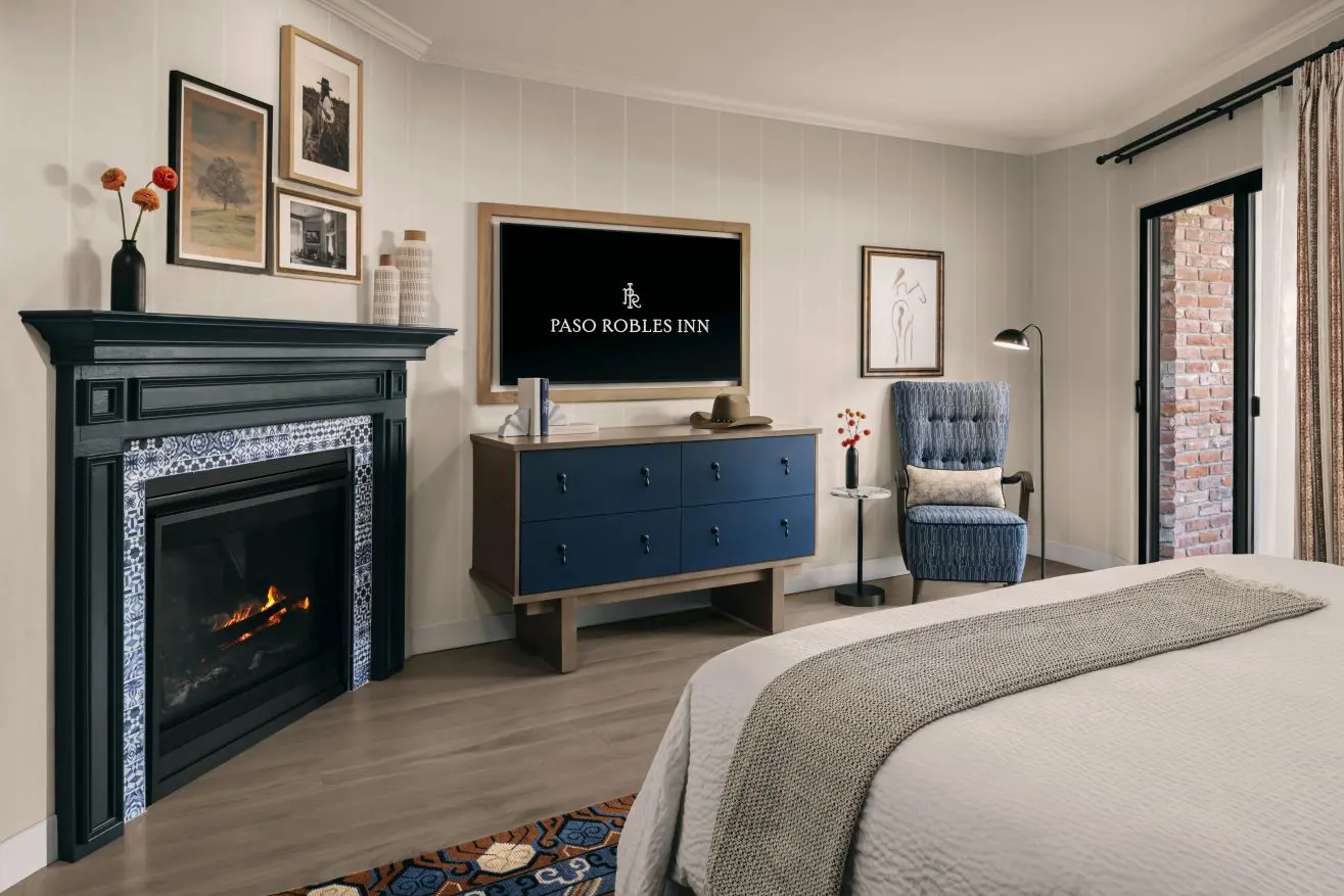 Fireplace and blue dresser in Garden Studio at Paso Robles Inn.