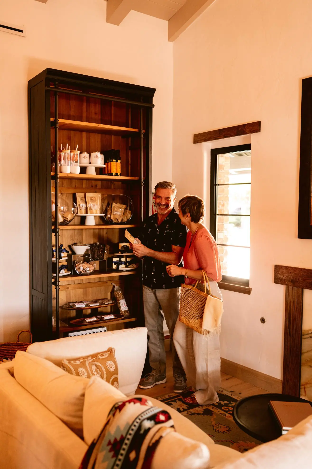 A man and a women looking at merchandise in a lobby.