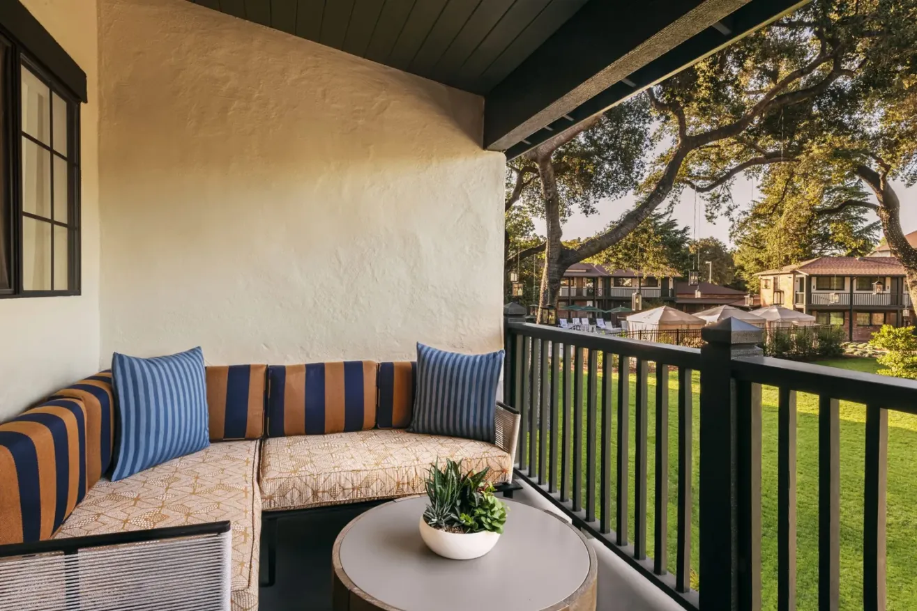 Garden Studio balcony looking out into the garden with a round table a large potted succulent at Paso Robles Inn.