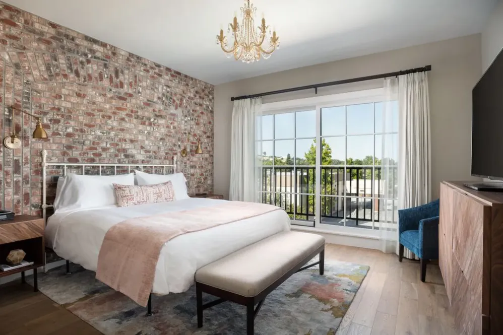 Bed against red brick wall