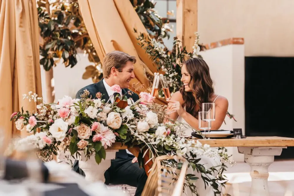 Bride and Groom cheers with champagne
